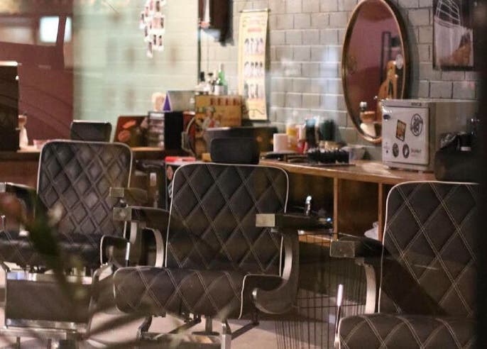 Cozy interior of St Martins Barber Shop in Diamond Creek, Victoria, AU featuring vintage-style barber chairs.