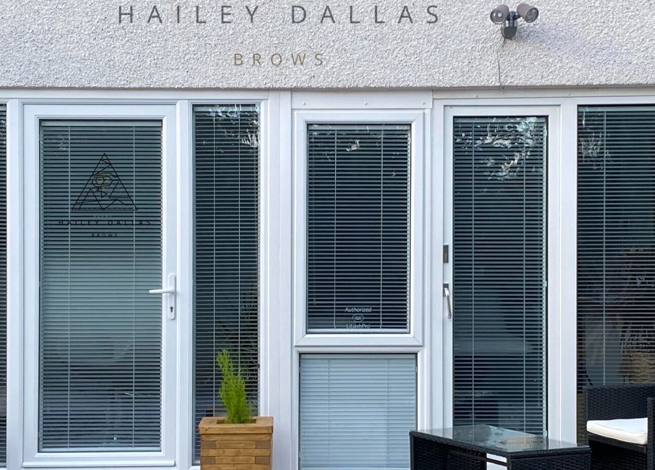 Hailey Dallas Brows in Lhanbryde, Scotland, GB, features a modern glass door entrance with sleek design.