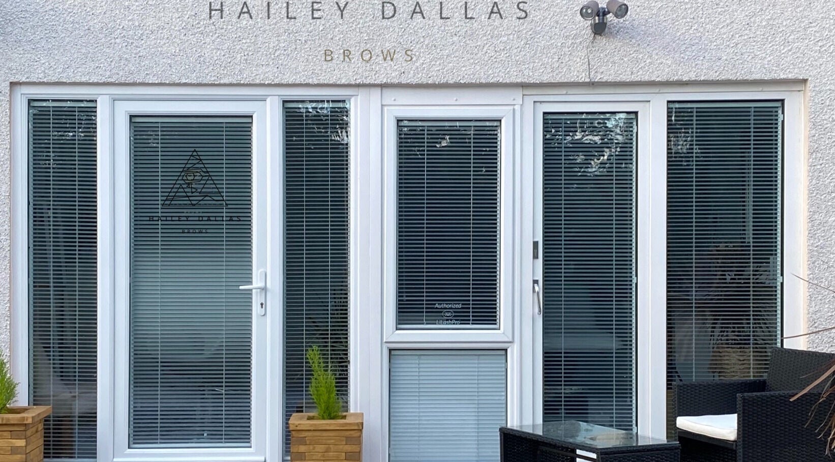 Hailey Dallas Brows in Lhanbryde, Scotland, GB, features a modern glass door entrance with sleek design.