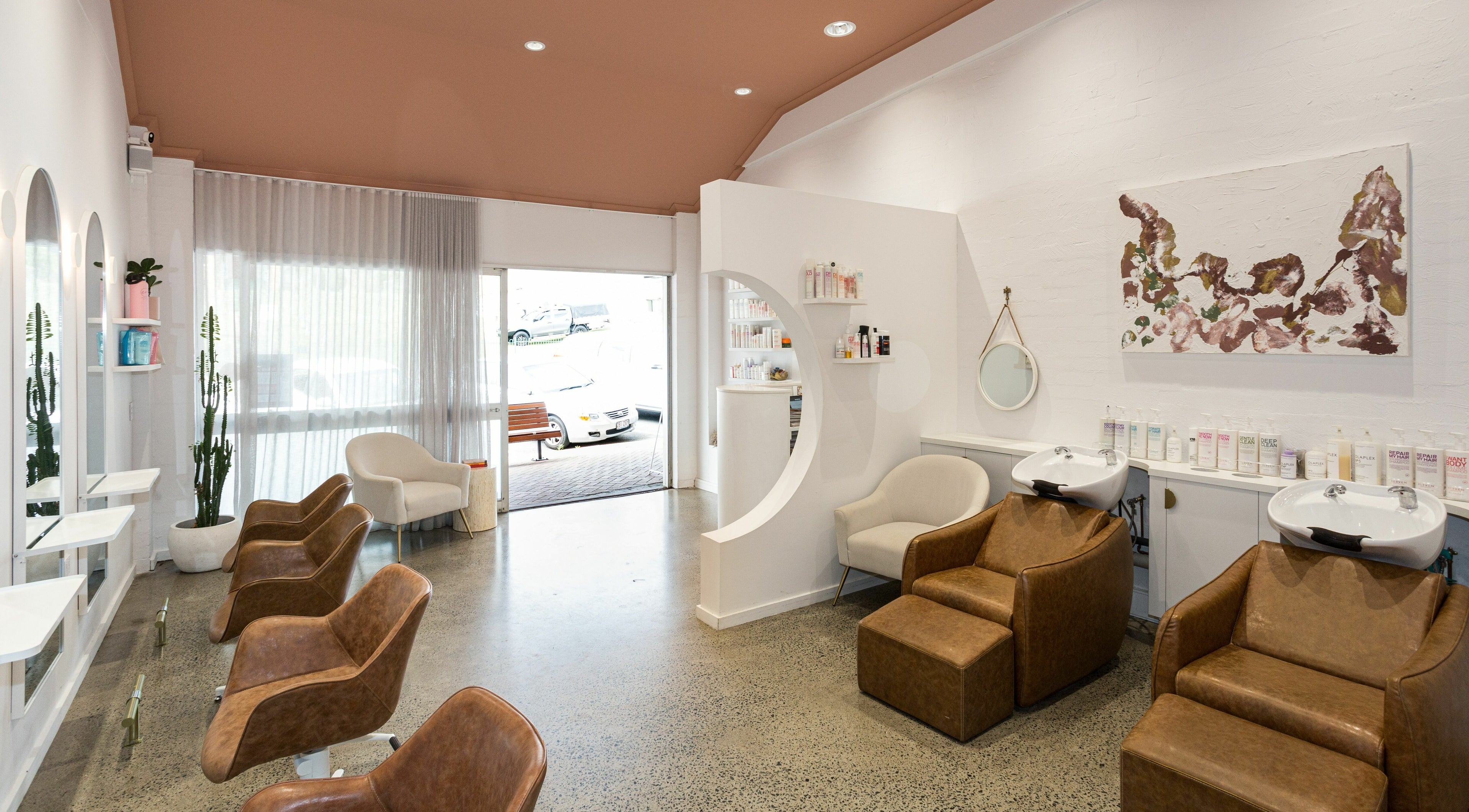 Modern salon interior at Elise Rae Hair Studio, Burleigh Heads, Queensland, AU, featuring stylish seating and decor.