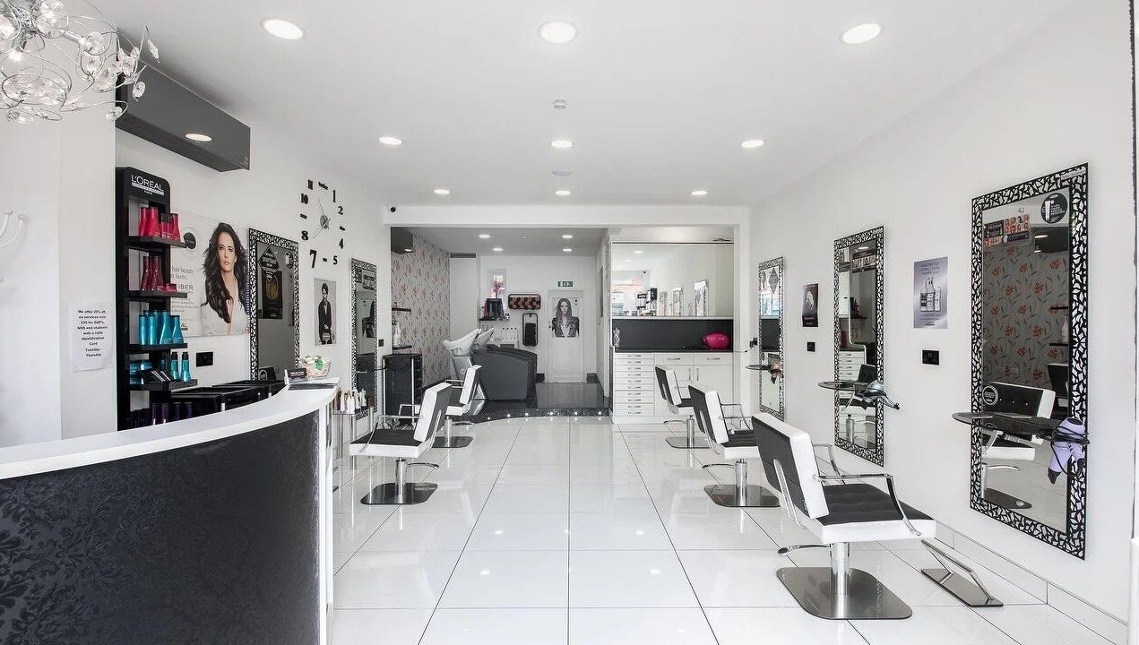 Stylish interior of Reflection Hair Studio in Potters Bar, England, GB with modern decor and elegant chairs.