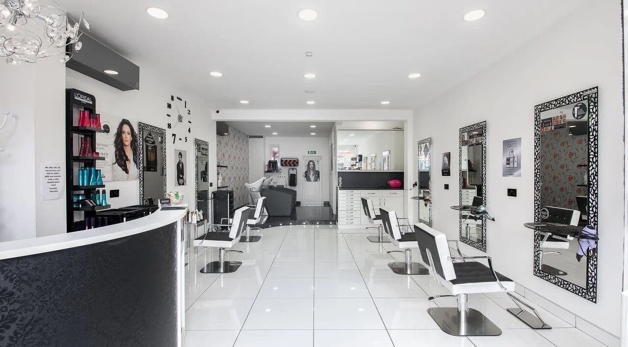 Stylish interior of Reflection Hair Studio in Potters Bar, England, GB with modern decor and elegant chairs.