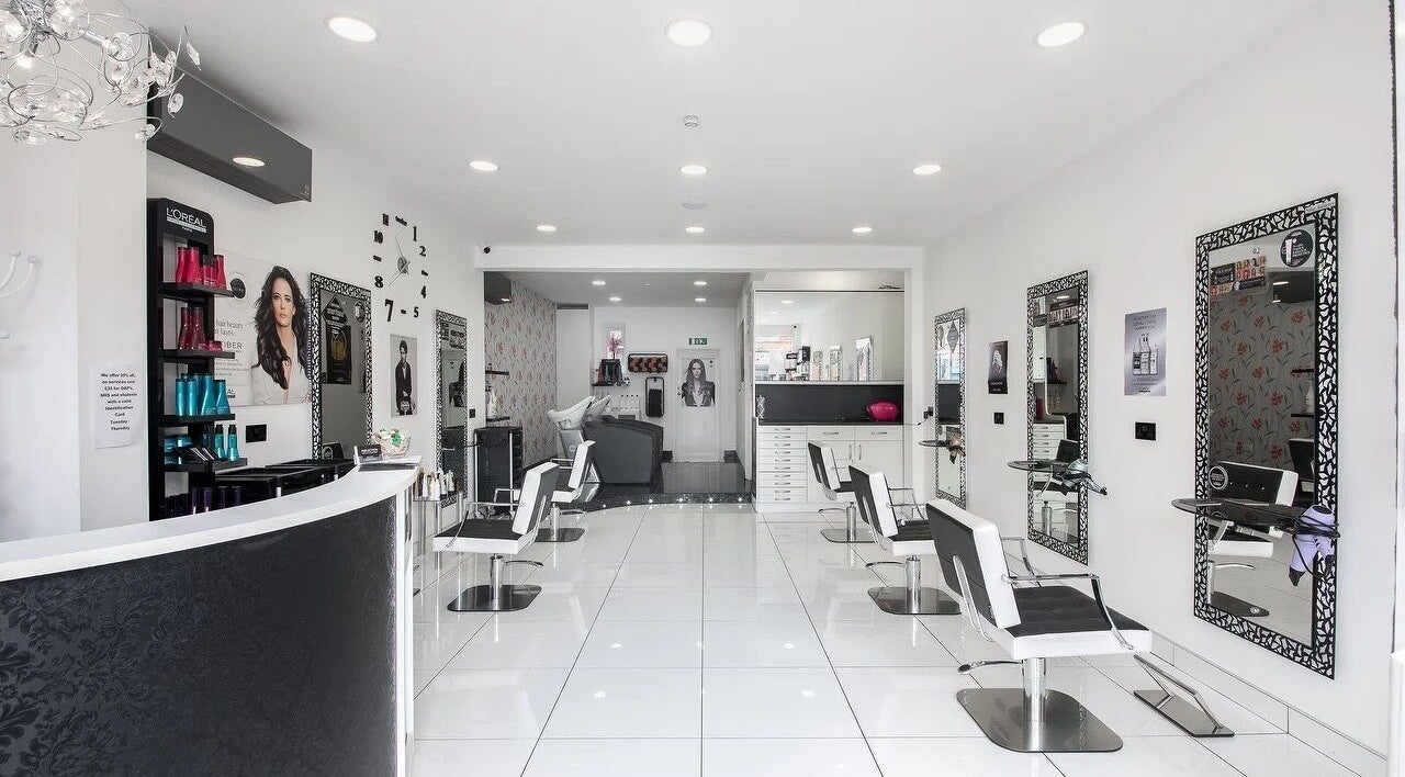 Stylish interior of Reflection Hair Studio in Potters Bar, England, GB with modern decor and elegant chairs.