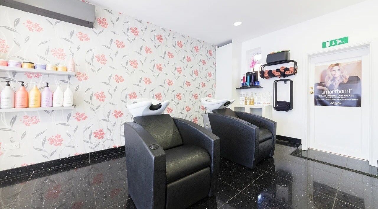 Modern shampoo station at Reflection Hair Studio in Potters Bar, England, GB with stylish chairs and floral decor.
