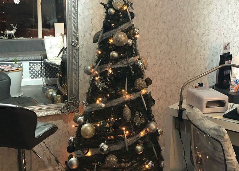Festive Christmas tree in The Chi Rooms, Essington, England, GB adorned with elegant decorations.