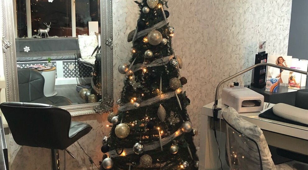 Festive Christmas tree in The Chi Rooms, Essington, England, GB adorned with elegant decorations.