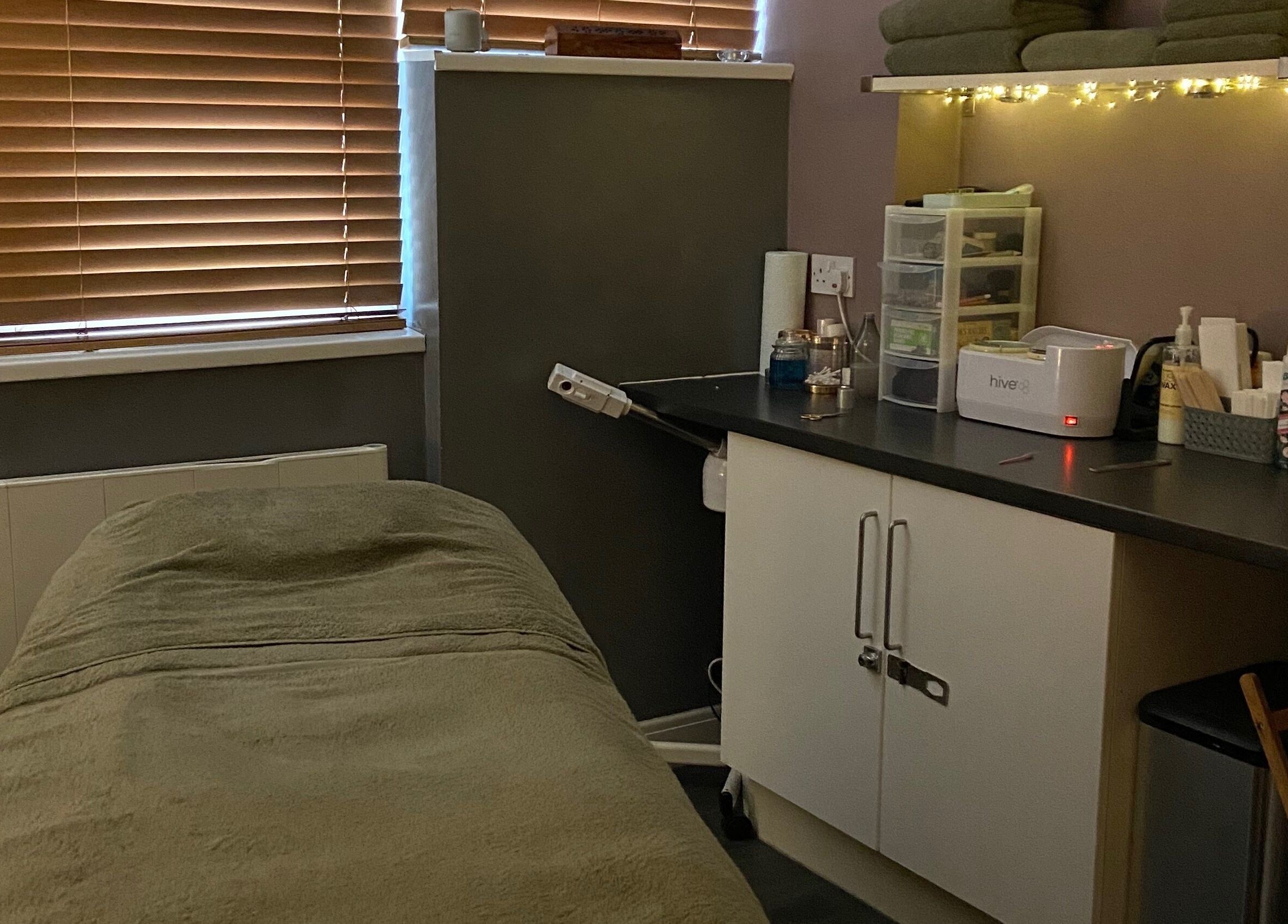 Cozy treatment room at The Chi Rooms, Essington, England, GB, featuring a massage table and soothing decor.
