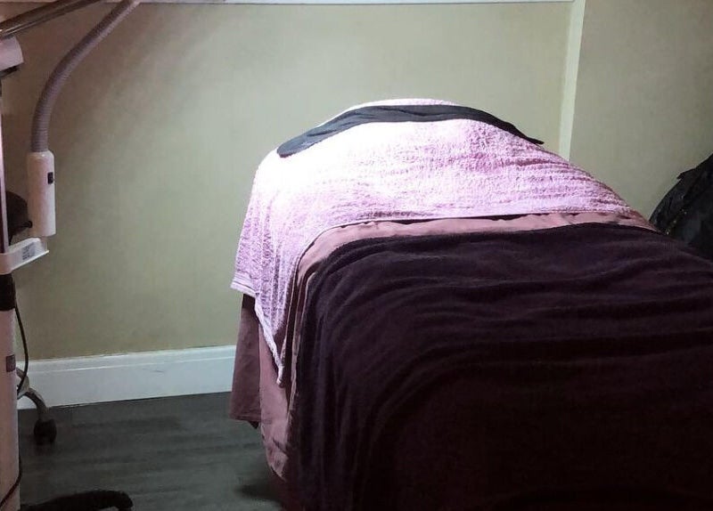 Relaxing massage room at The Chi Rooms, Essington, England, GB with cozy bed and ambient lighting.