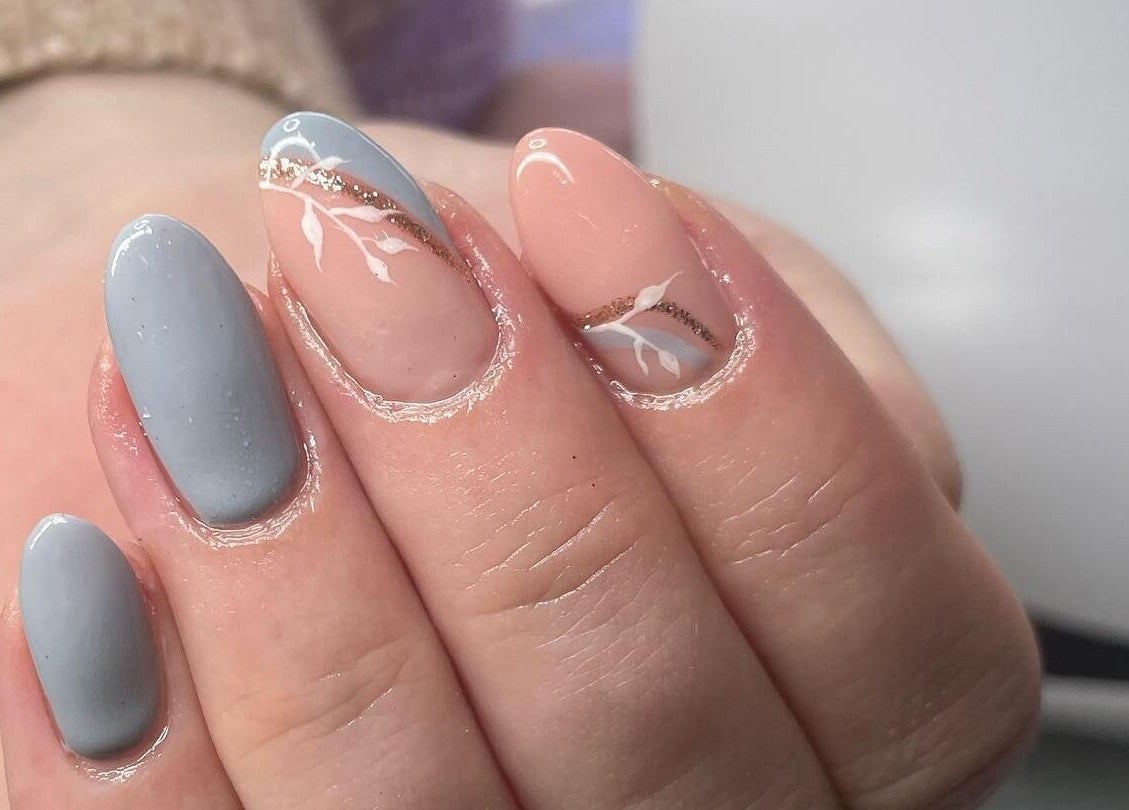 Elegant nail design at The Chi Rooms in Essington, England, GB showcasing blue and nude tones with delicate art.