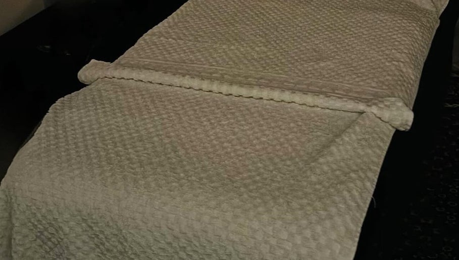 Massage table with elegant linens at Leyla’s Holistic Therapies, St Albans, England, GB. Relaxation assured.