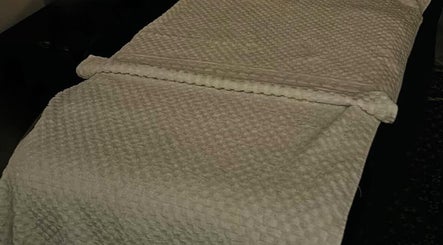 Massage table with elegant linens at Leyla’s Holistic Therapies, St Albans, England, GB. Relaxation assured.