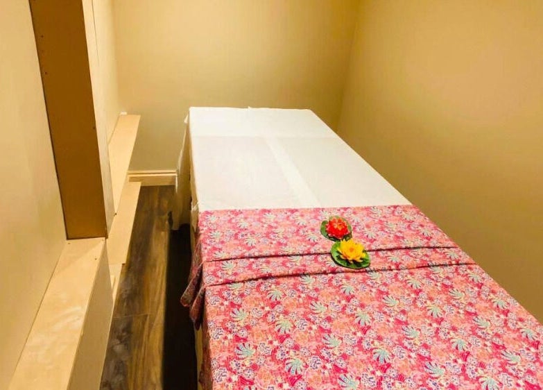 Comfortable massage room at Refresh and Spa Ltd in London, England, GB, featuring a floral-patterned cover.