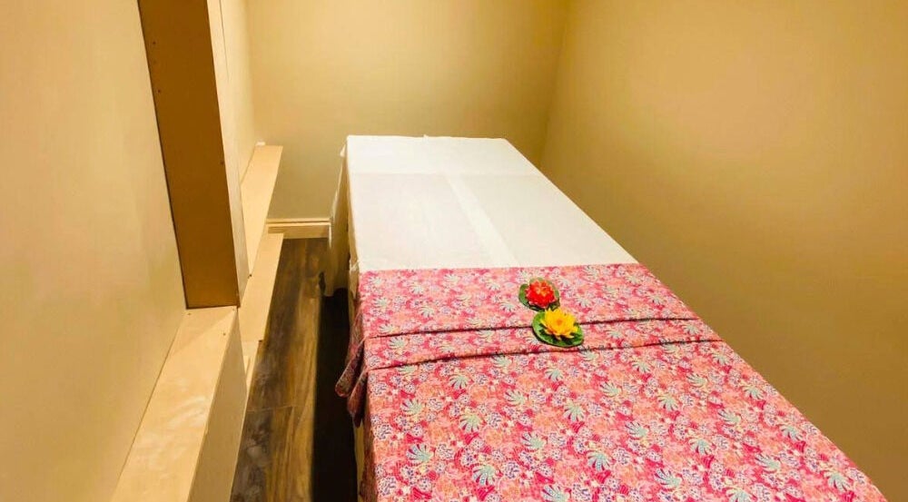 Comfortable massage room at Refresh and Spa Ltd in London, England, GB, featuring a floral-patterned cover.