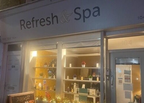 Night view of Refresh and Spa Ltd, a wellness venue in London, England, GB with warm interior lighting.