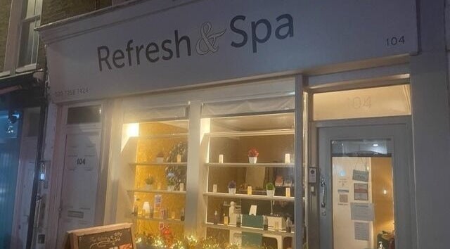 Night view of Refresh and Spa Ltd, a wellness venue in London, England, GB with warm interior lighting.