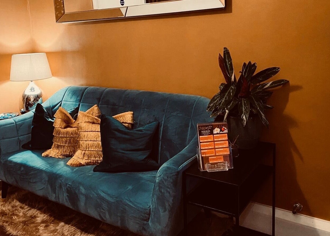 Stylish blue sofa with cushions in cozy area at Refresh and Spa Ltd, London, England, GB.