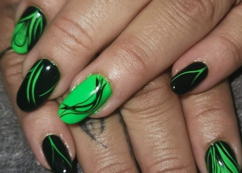 Stunning green and black nail art from The Nail Booth in Krugersdorp, Gauteng, ZA. Perfect for vibrant statements.