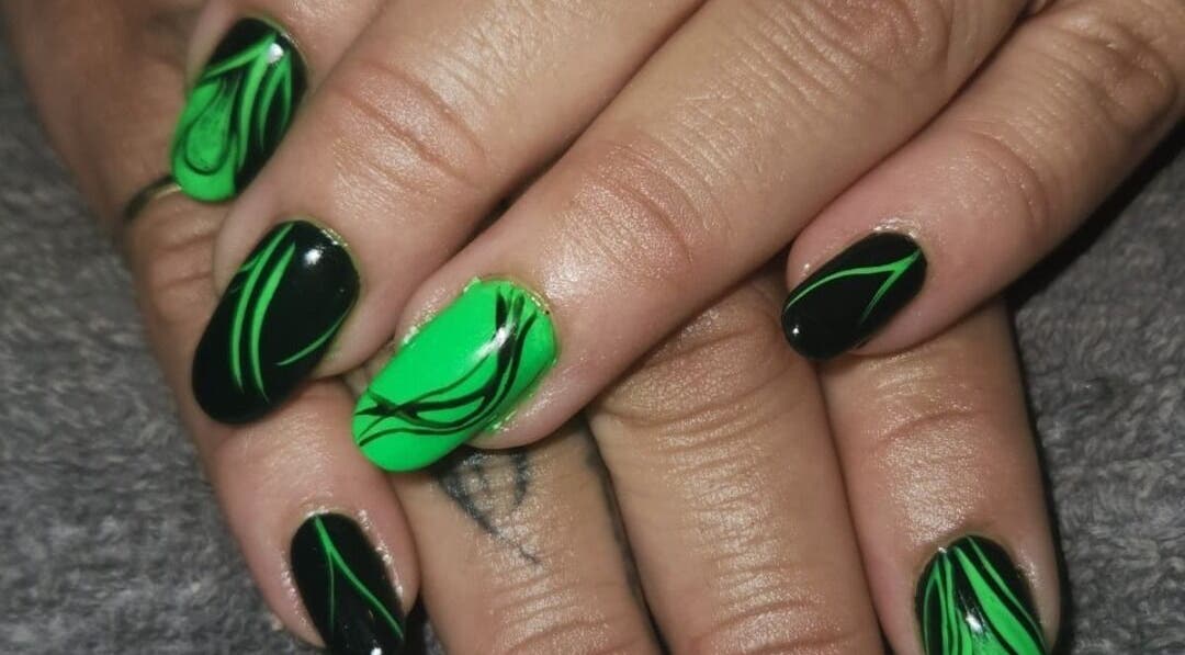Stunning green and black nail art from The Nail Booth in Krugersdorp, Gauteng, ZA. Perfect for vibrant statements.