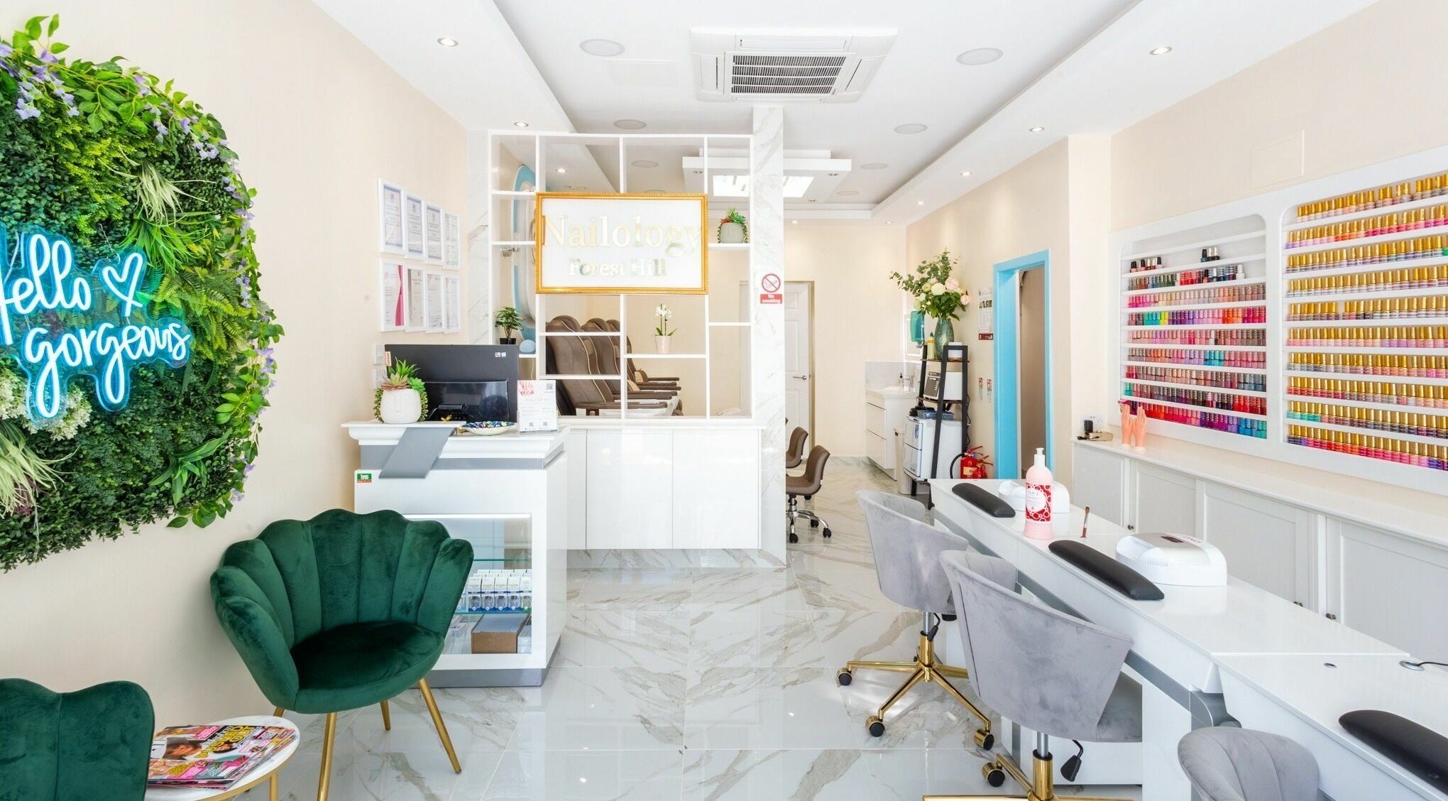 Elegant interior of Pamper Nail Bar in London, England, GB. Modern, bright space with nail polish display and seating.
