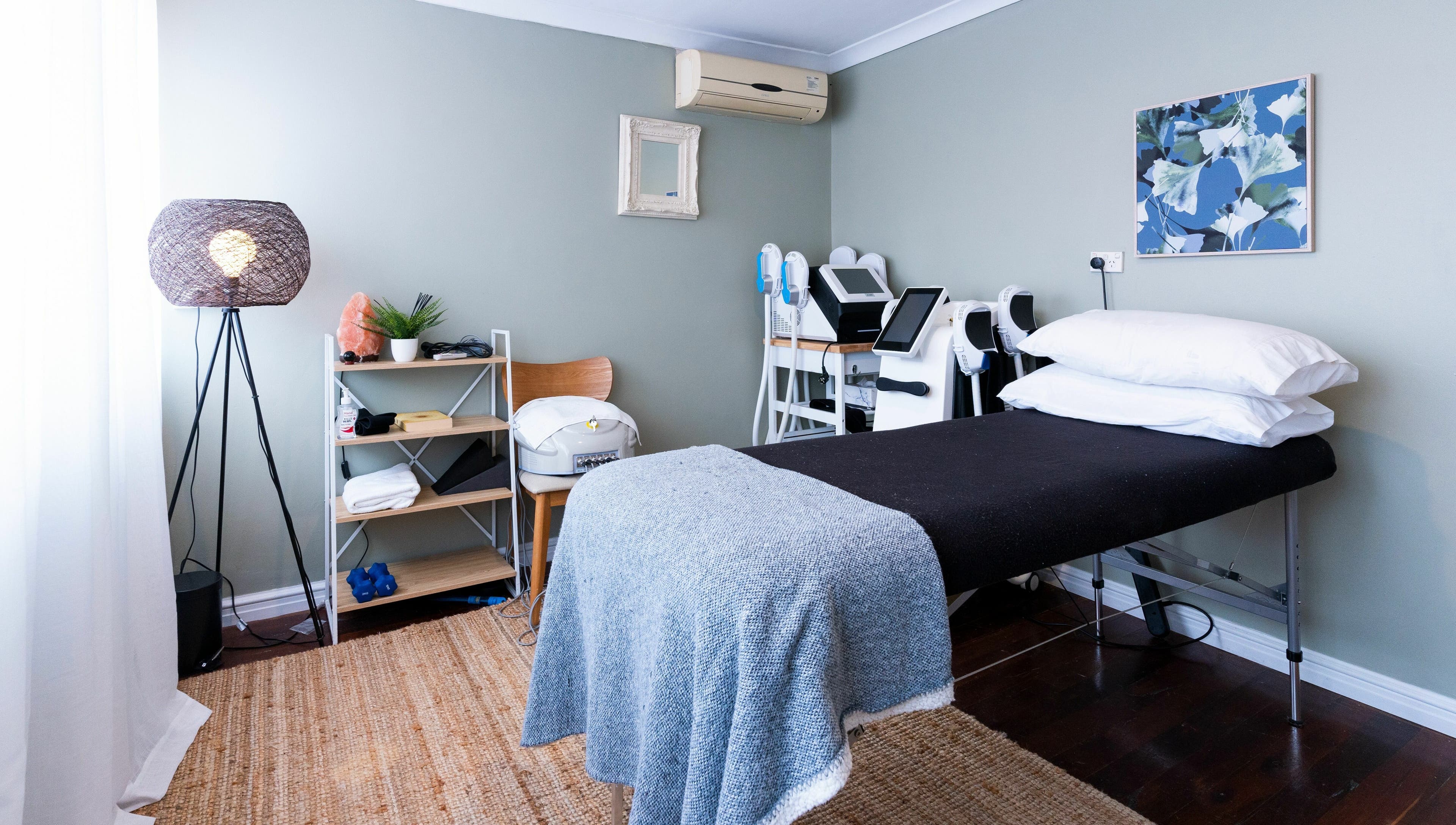 Cozy treatment room at Peachy Body Sculpting, Tuart Hill, Western Australia, AU, featuring massage bed and decor.
