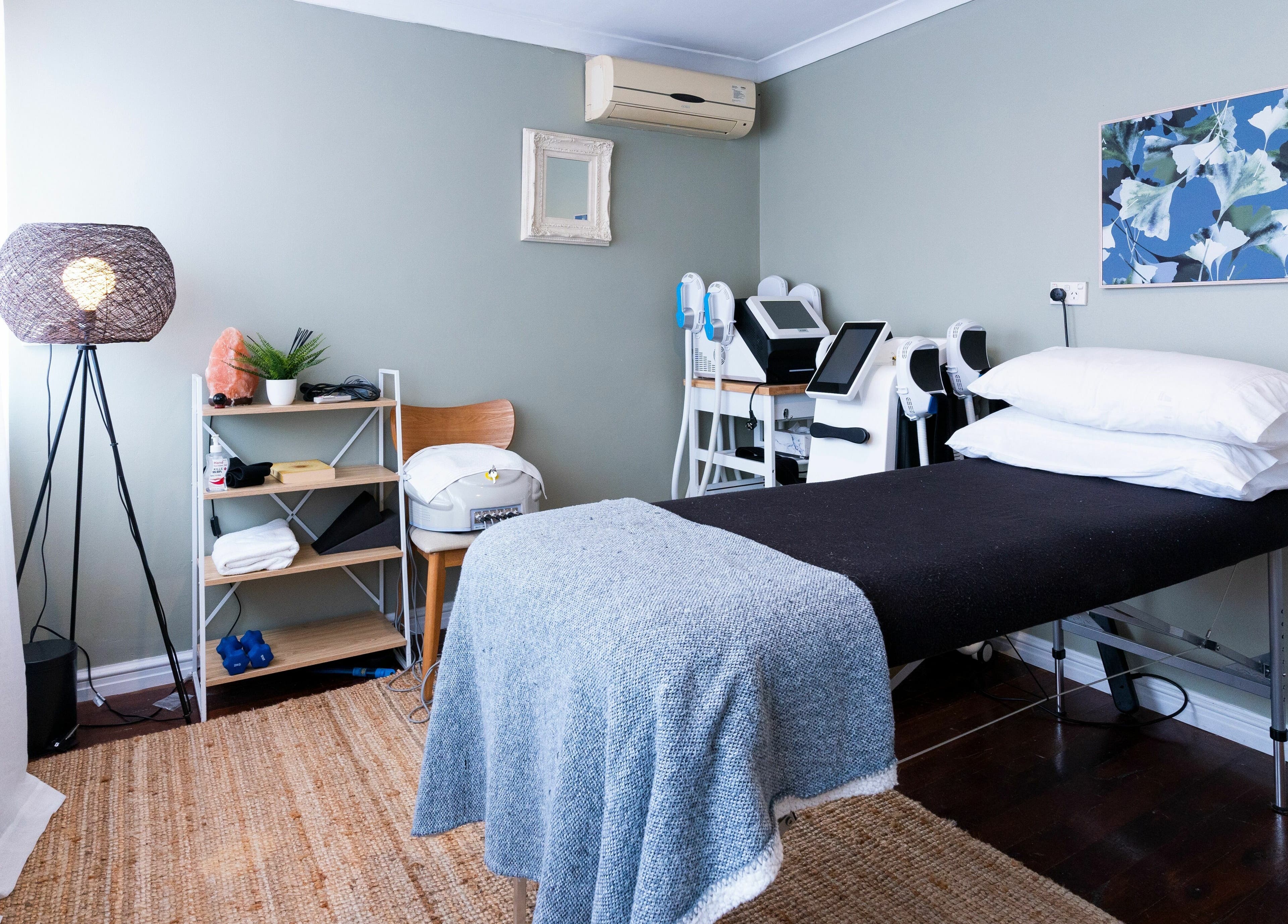 Cozy treatment room at Peachy Body Sculpting, Tuart Hill, Western Australia, AU, featuring massage bed and decor.
