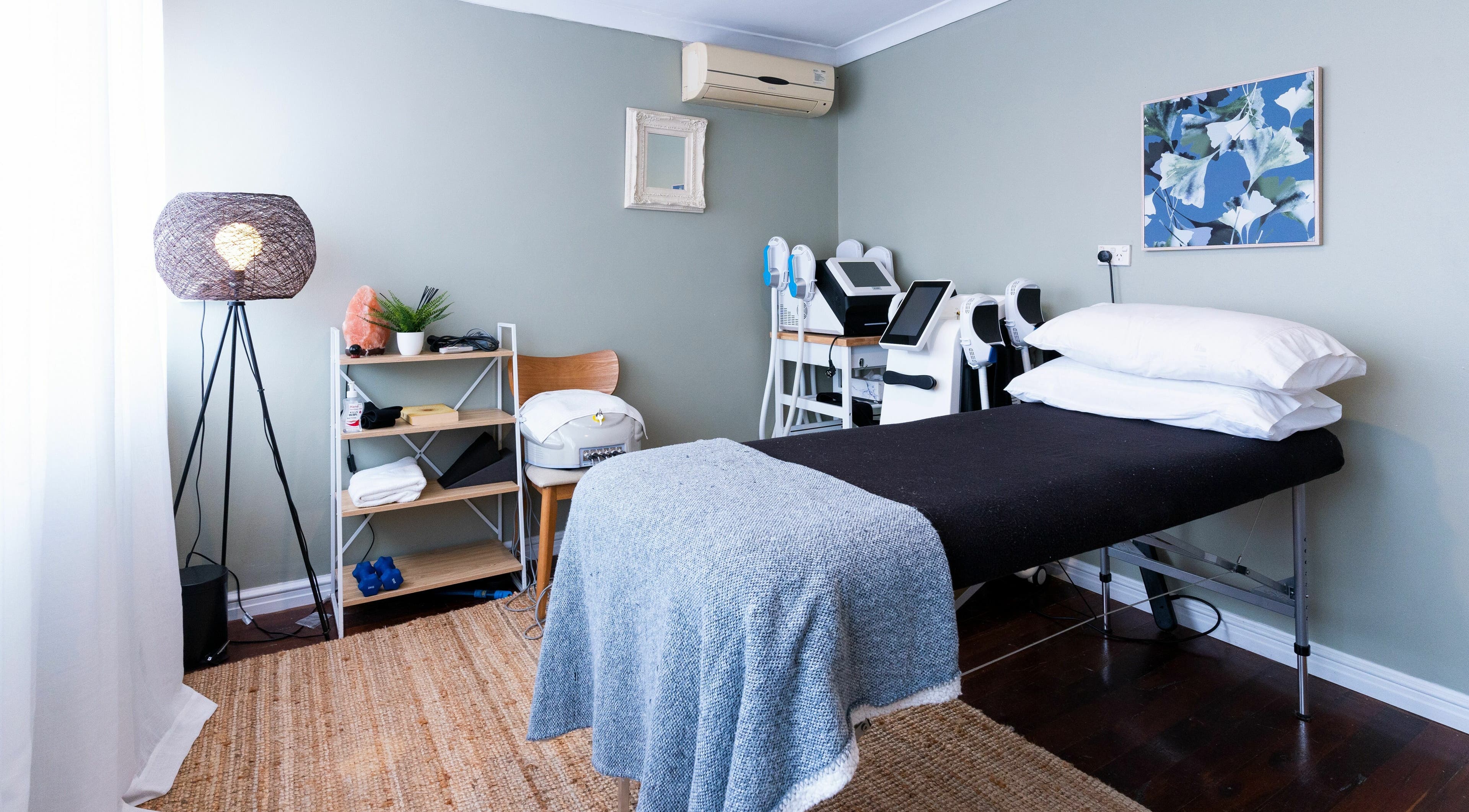 Cozy treatment room at Peachy Body Sculpting, Tuart Hill, Western Australia, AU, featuring massage bed and decor.