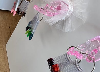 Nail polish samples on pink crystal hand at Savannah Sky Salon, Neyland, Wales, GB.