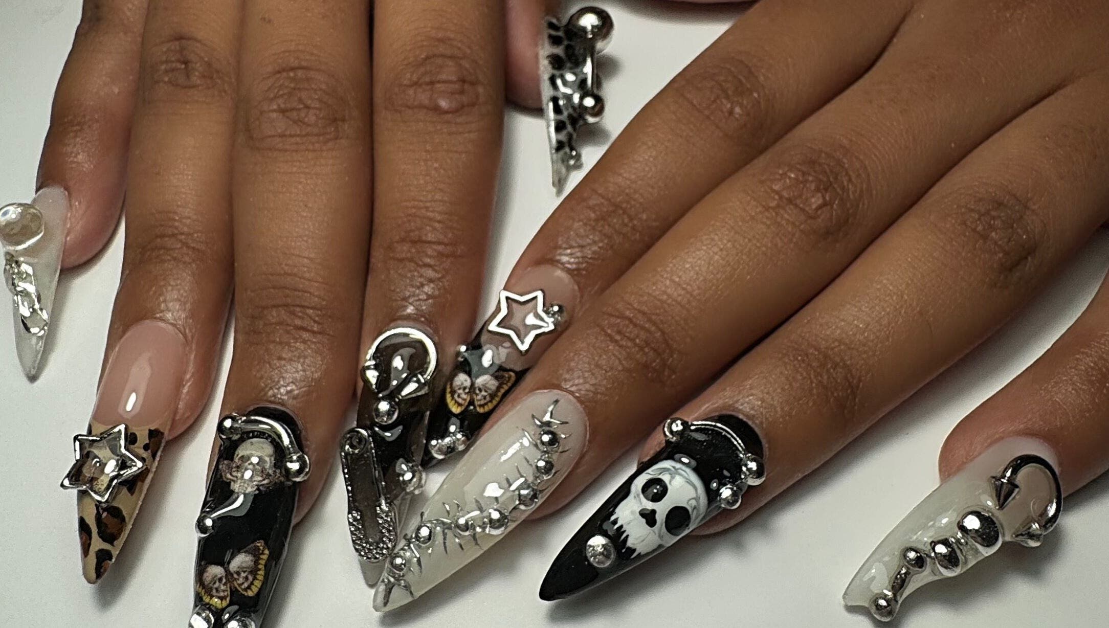 Intricate nail art at Gellraiser, Brighton And Hove, England, GB, featuring silver and black decorative designs.