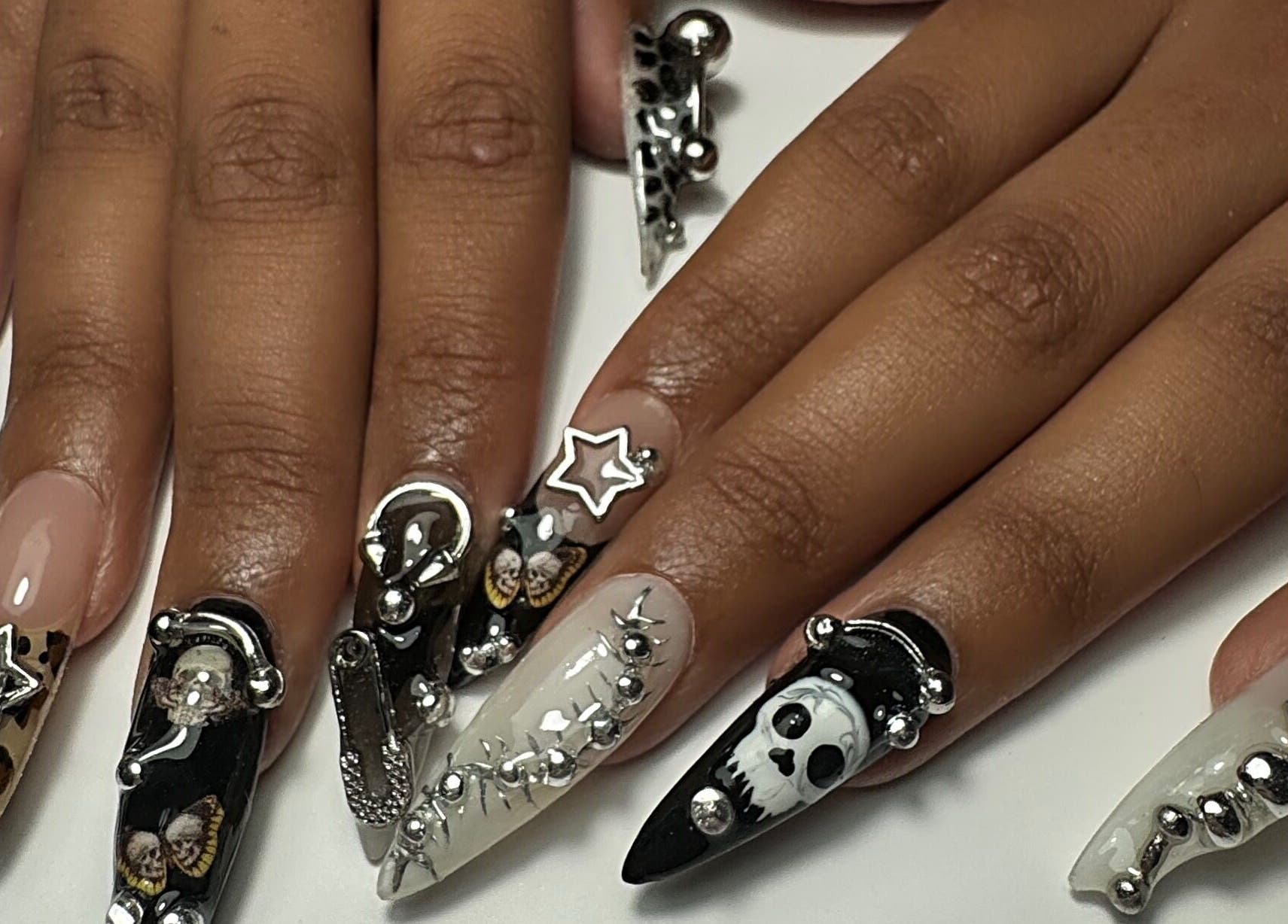 Intricate nail art at Gellraiser, Brighton And Hove, England, GB, featuring silver and black decorative designs.