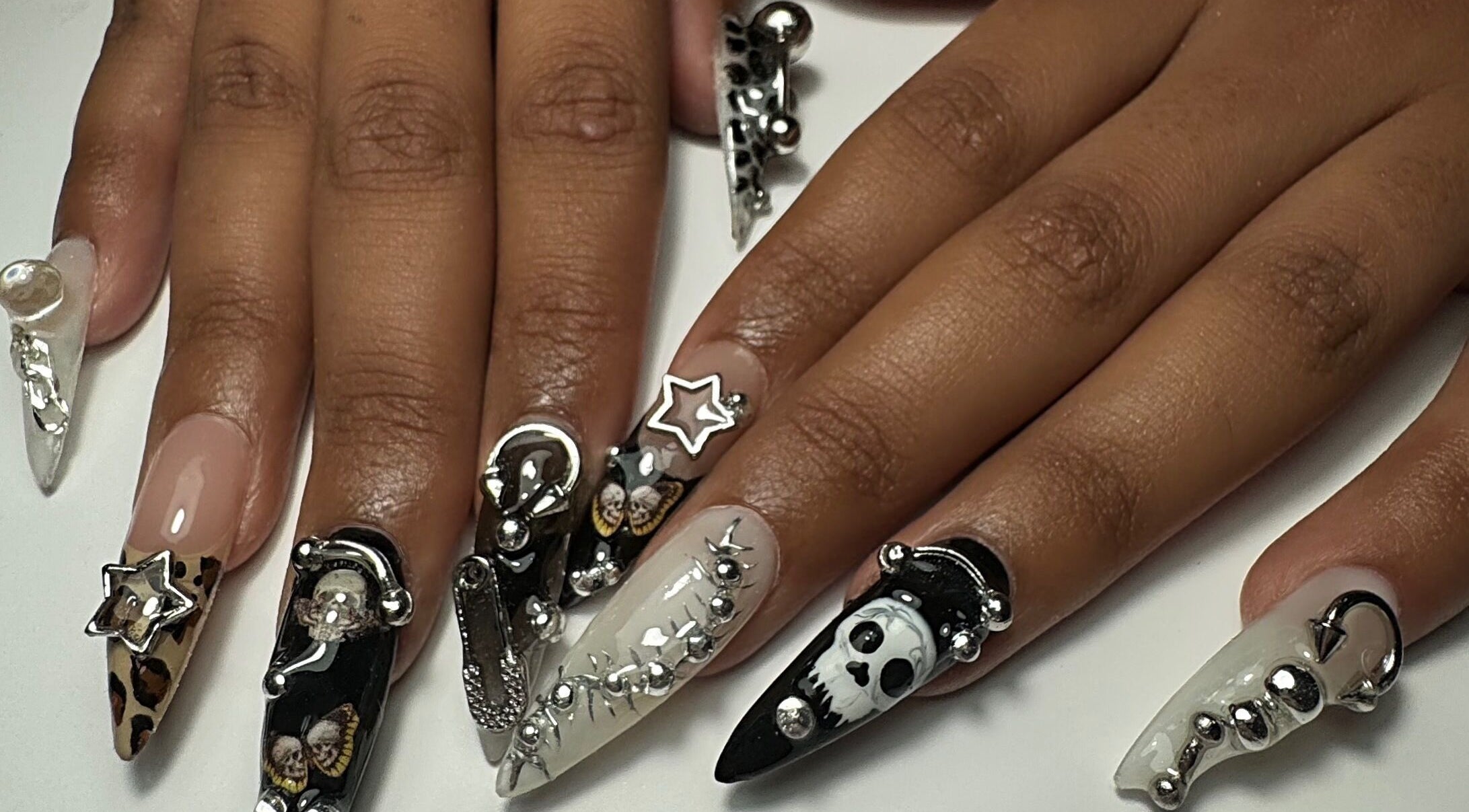 Intricate nail art at Gellraiser, Brighton And Hove, England, GB, featuring silver and black decorative designs.