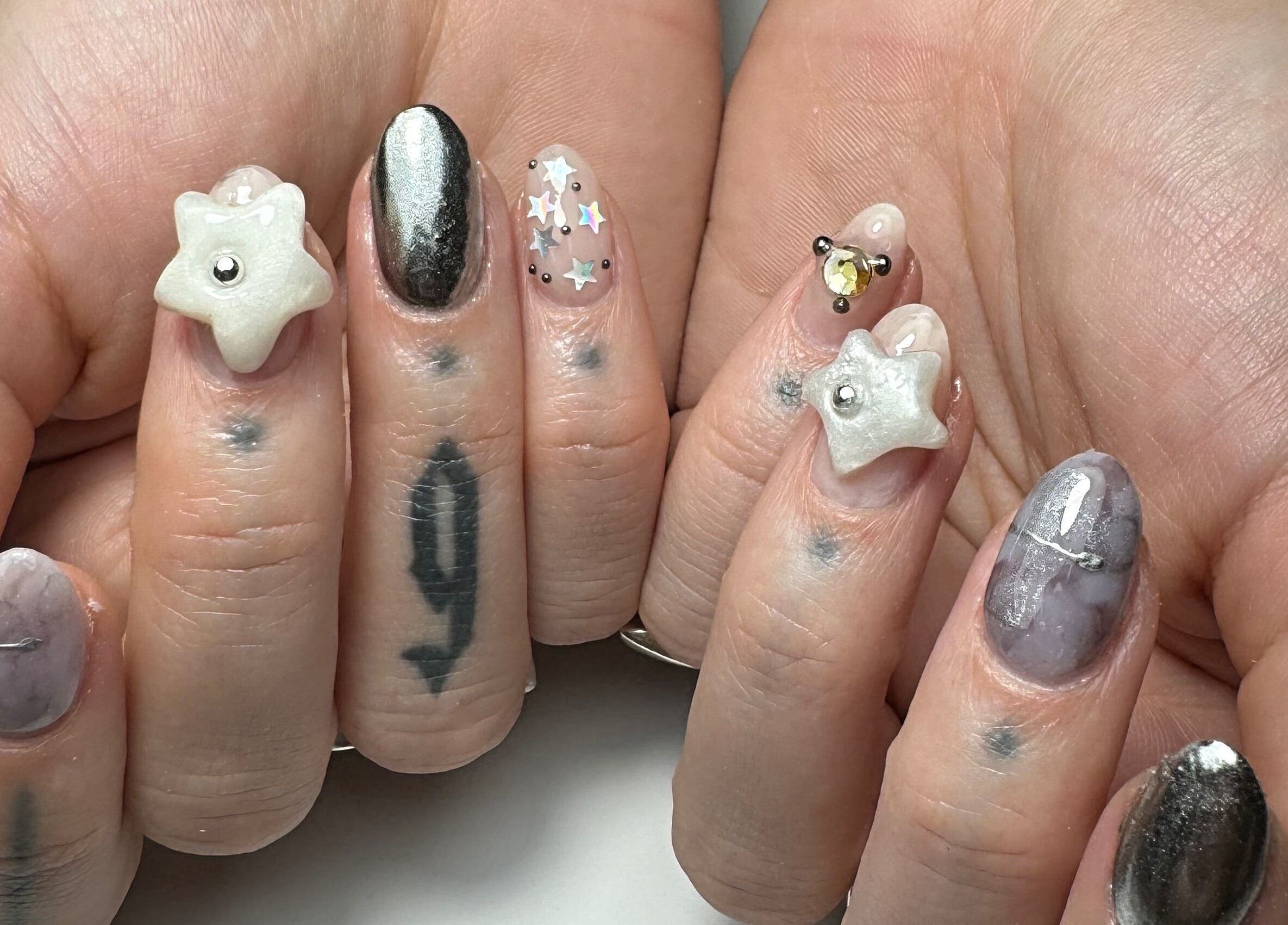 Artistic star-themed nails at Gellraiser in Brighton And Hove, England, GB showcasing unique designs.