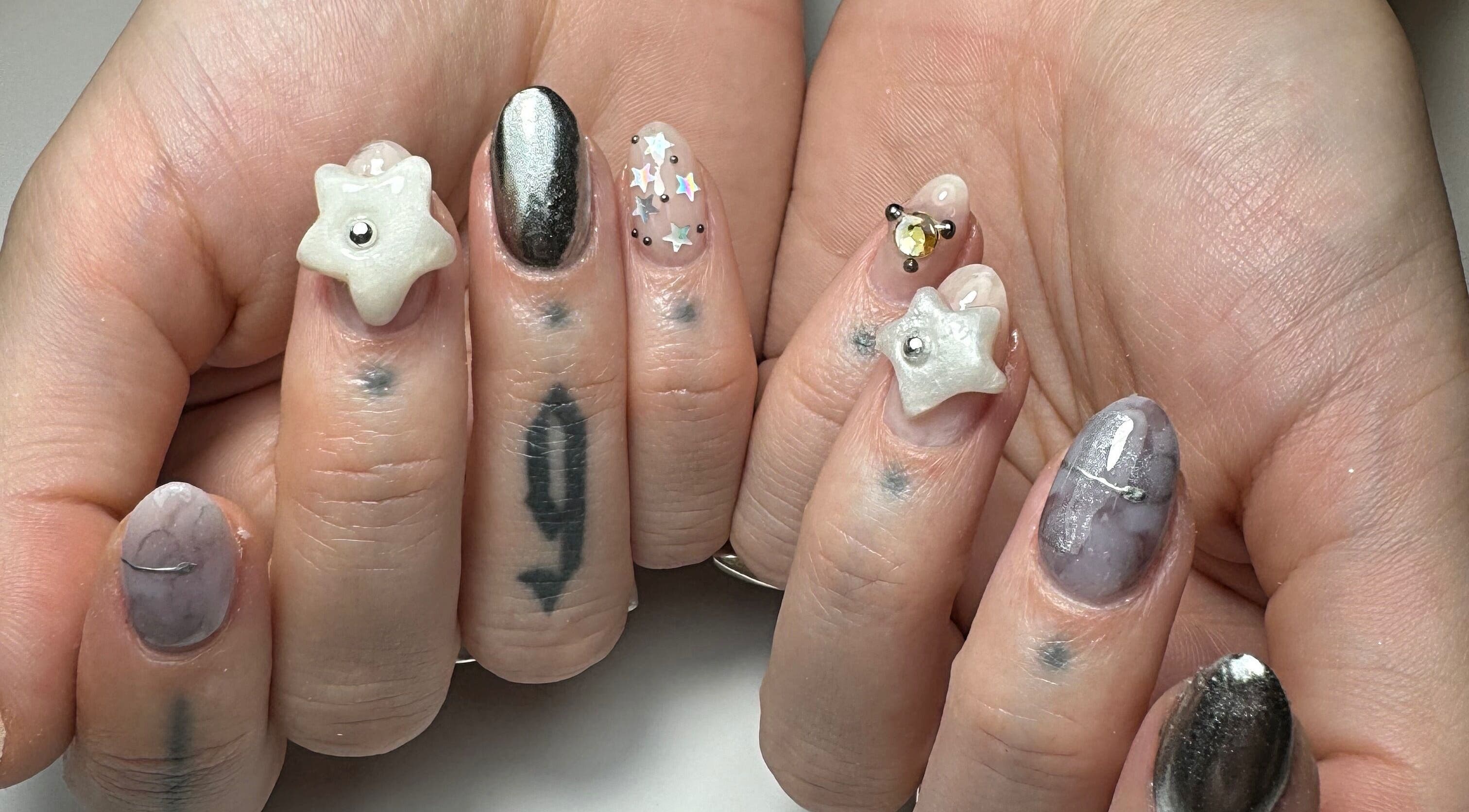 Artistic star-themed nails at Gellraiser in Brighton And Hove, England, GB showcasing unique designs.