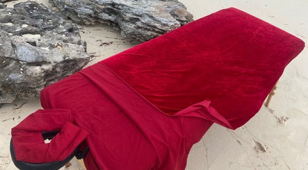 Massage table with red cover at Body and Skin Treatments by Michelle, Nassau, New Providence, BS.