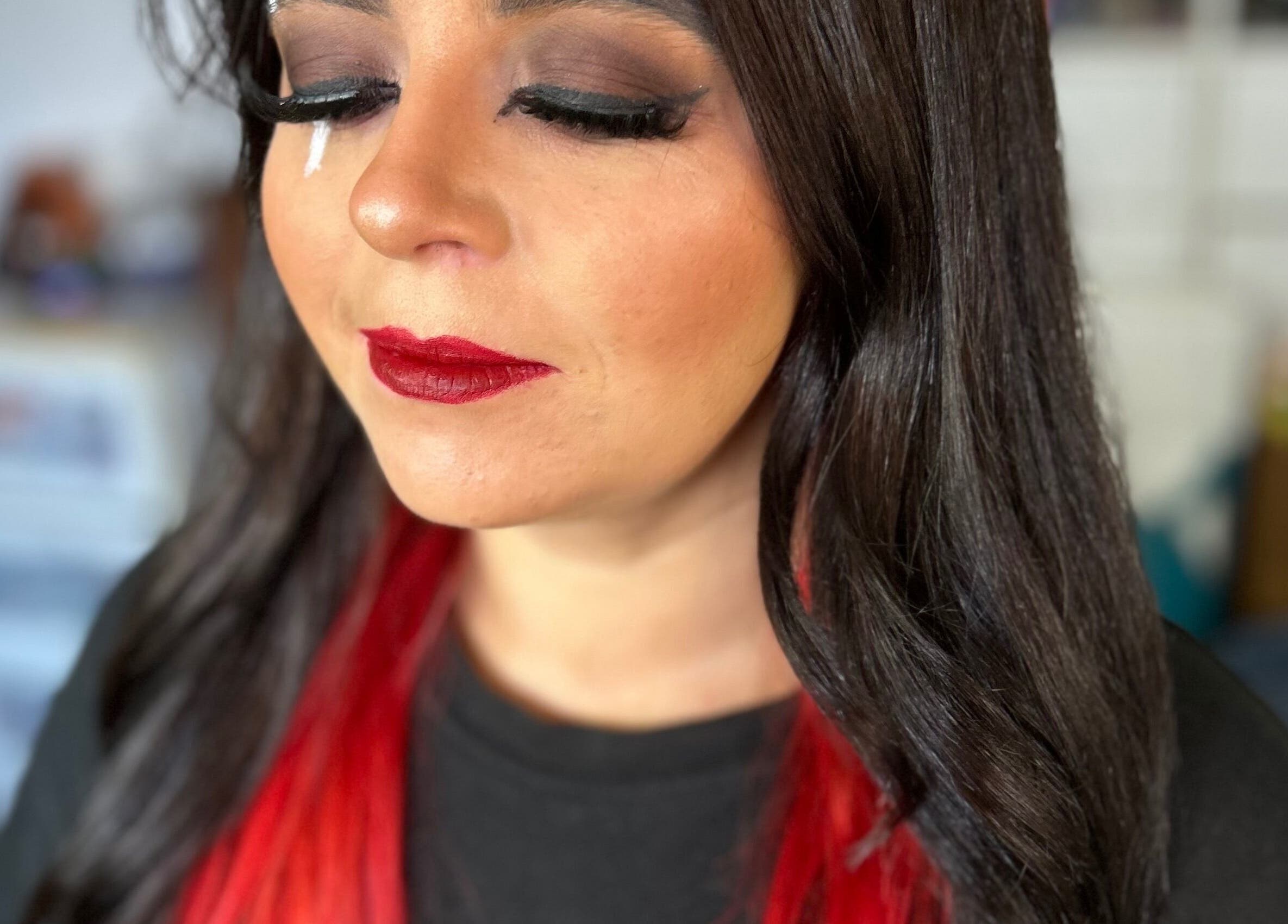Glamorous makeup at Beauty by Hailey Anderson, Larkhall, Scotland. Bold red lips and striking red-black hair.
