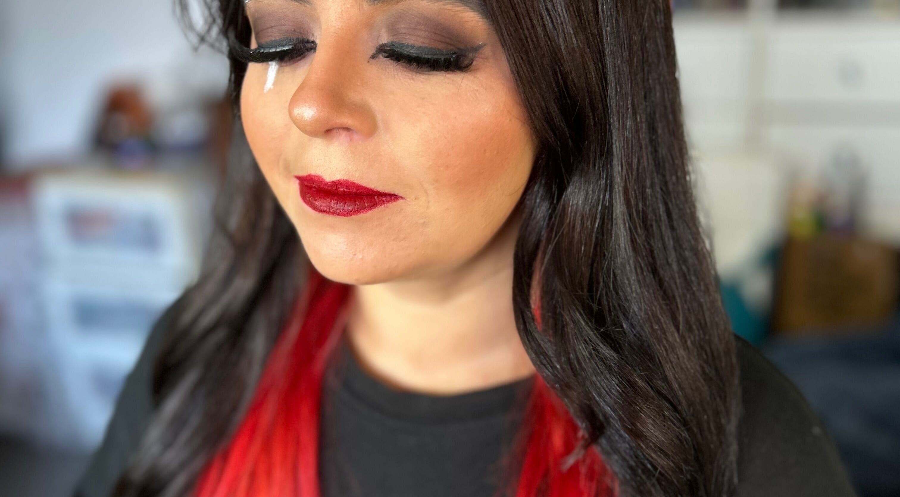 Glamorous makeup at Beauty by Hailey Anderson, Larkhall, Scotland. Bold red lips and striking red-black hair.
