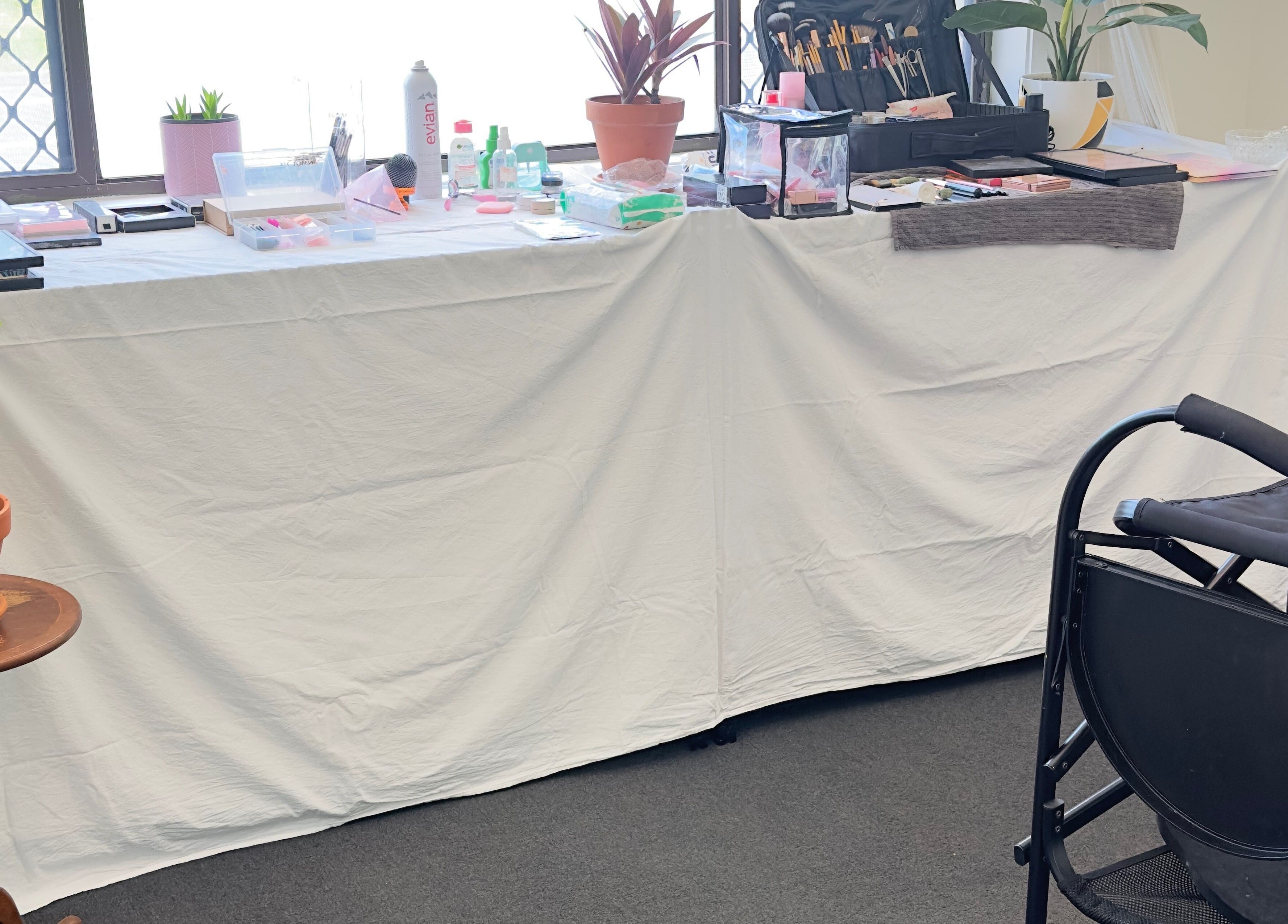 Makeup station at Dreamy Looks By Kara in Ashmore, Queensland, AU, featuring beauty tools and plants.