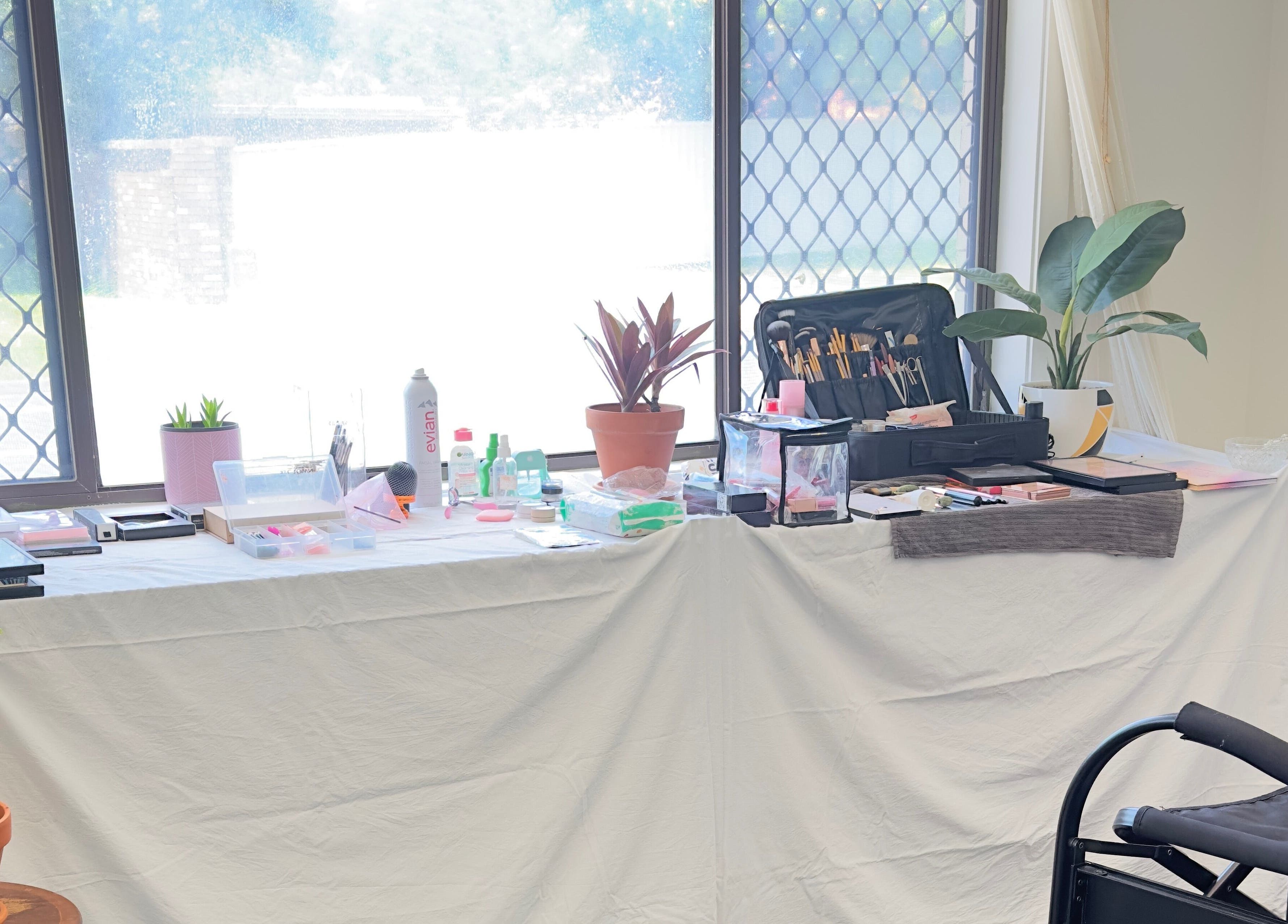 Makeup setup at Dreamy Looks By Kara, Ashmore, Queensland, AU, with brushes and products on a white-draped table.