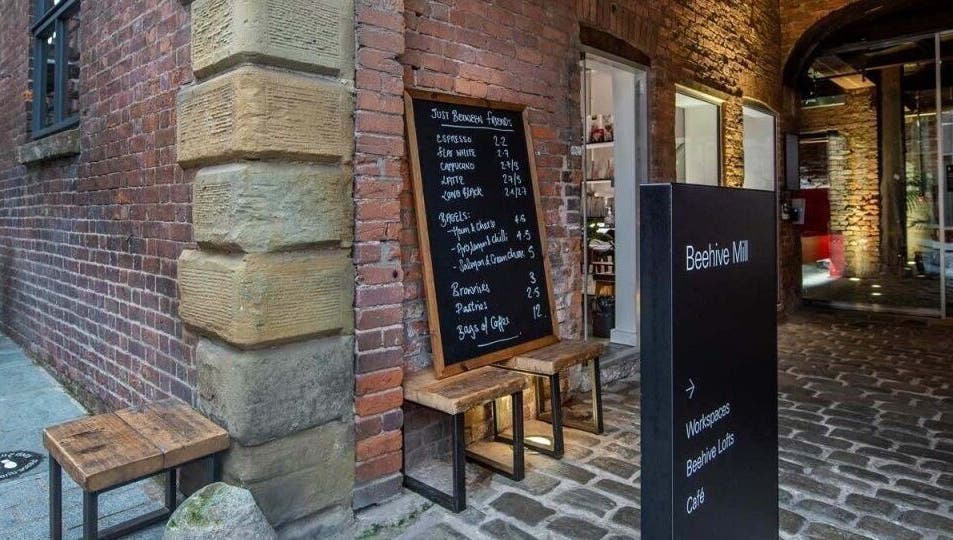 Entrance at Beehive Mill with menu board outside Manchester Lashes | Jean Studios in Ancoats, Manchester, England, GB.