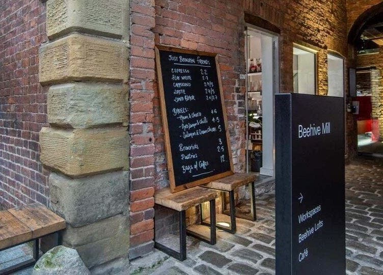 Entrance at Beehive Mill with menu board outside Manchester Lashes | Jean Studios in Ancoats, Manchester, England, GB.