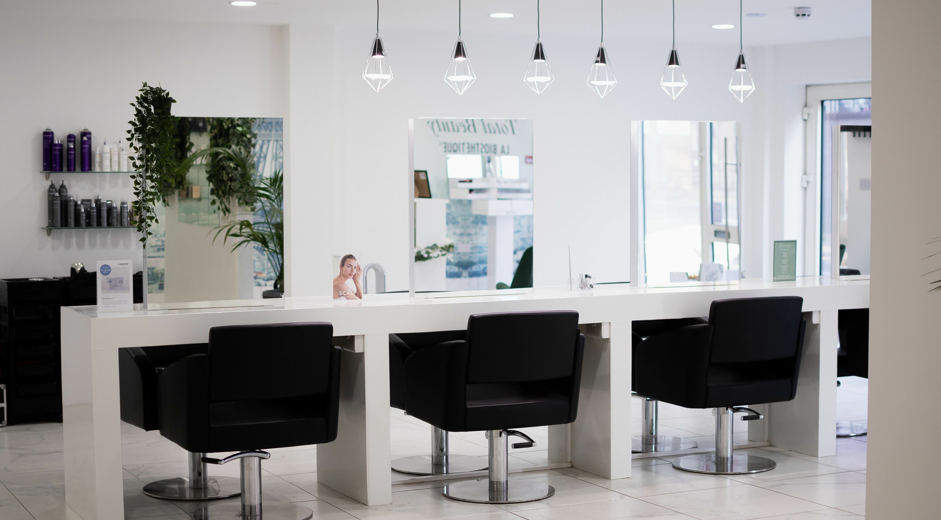 Modern salon chairs and mirrors at Serenity Hair & Spa, Camberley, England, GB.
