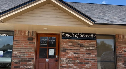 Front entrance of Touch of Serenity Wellness Spa in Moore, Oklahoma, US, with sign and brick exterior.