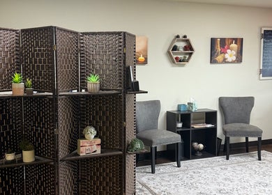Relaxing lounge area at Touch of Serenity Wellness Spa, Moore, Oklahoma, US with elegant decor and cozy seating.
