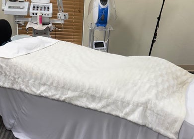Luxurious spa bed at Touch of Serenity Wellness Spa in Moore, Oklahoma, US, ready for relaxation and rejuvenation.