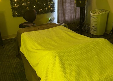 Cozy massage room at Touch of Serenity Wellness Spa in Moore, Oklahoma, US with ambient lighting and relaxing decor.
