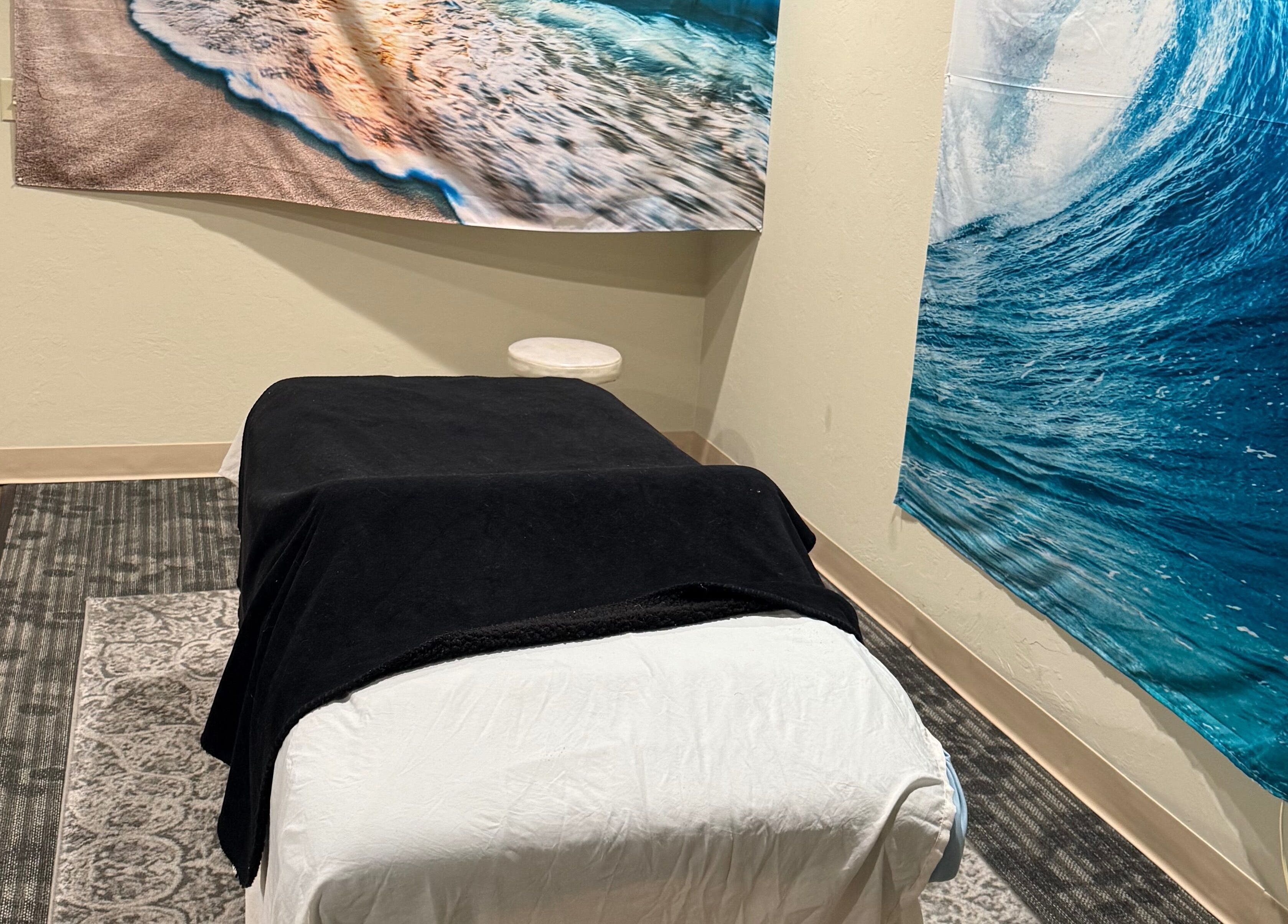 Relaxing massage room at Touch of Serenity Wellness Spa with beach murals, Moore, Oklahoma, US.