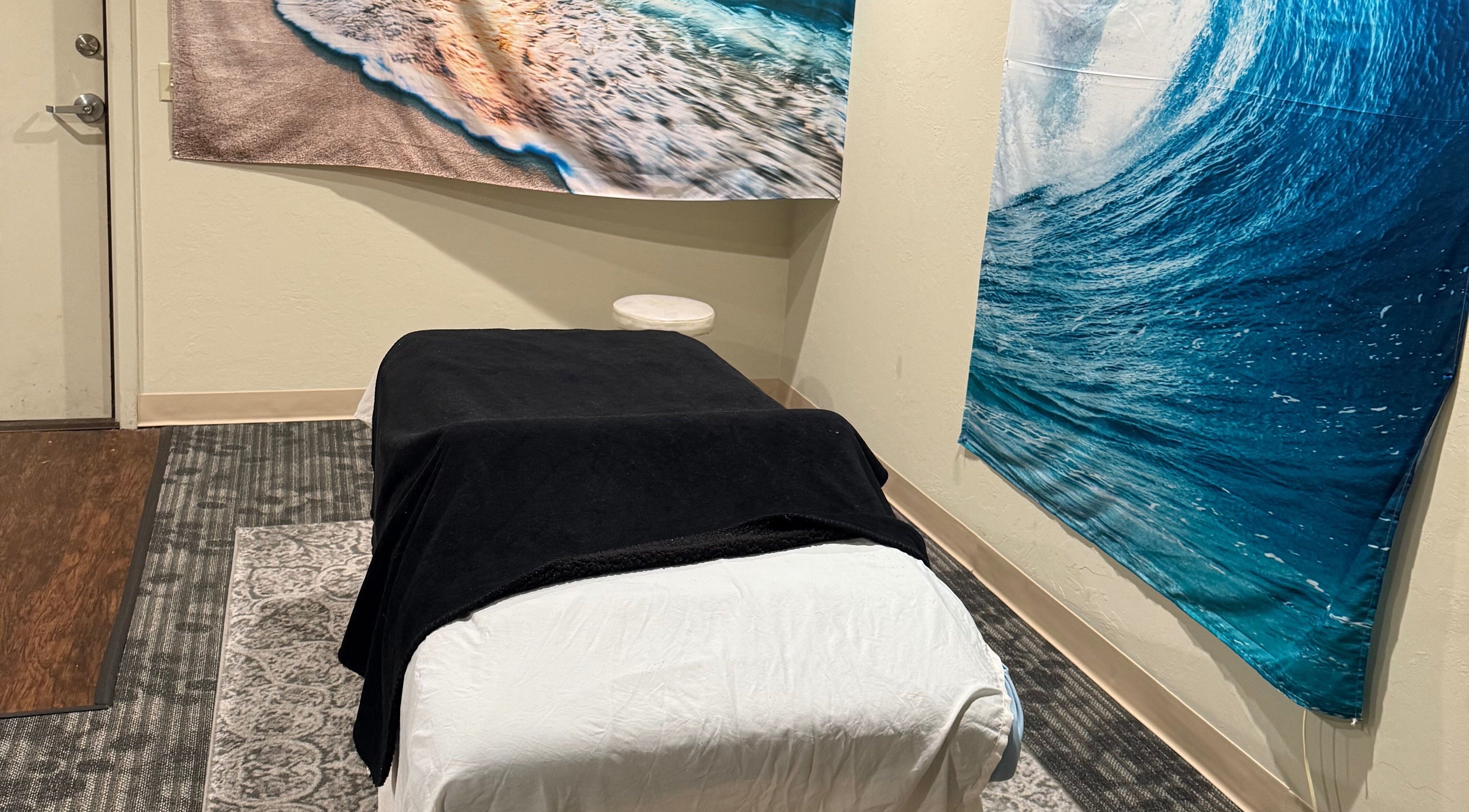Relaxing massage room at Touch of Serenity Wellness Spa with beach murals, Moore, Oklahoma, US.