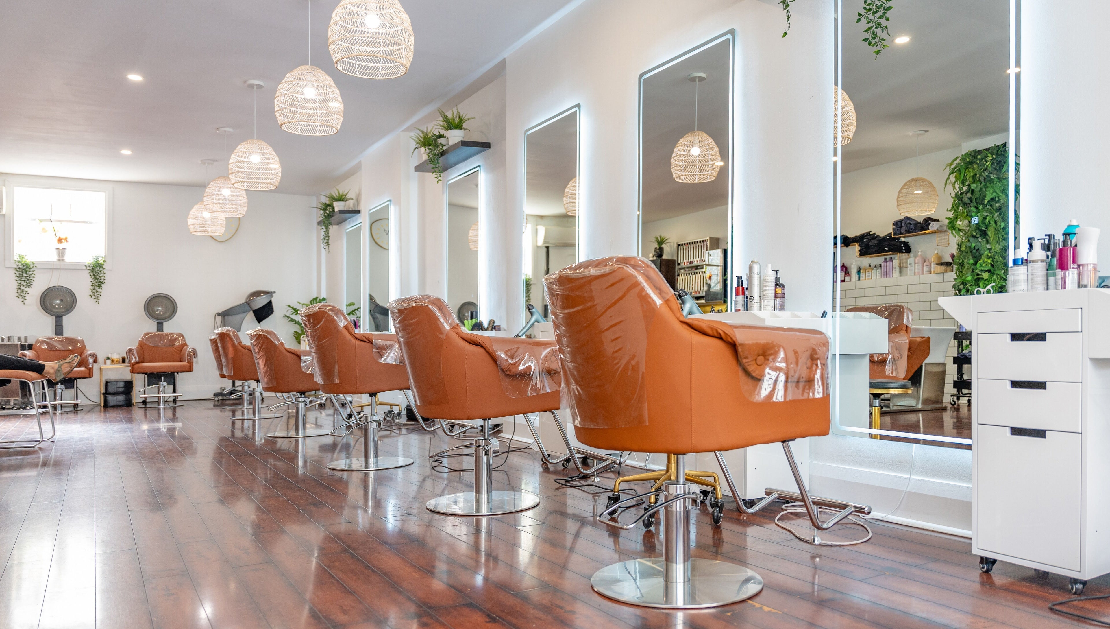 Modern salon interior with plush chairs at The Curl Lounge, Toronto, Ontario, CA, showcasing sleek design aesthetics.