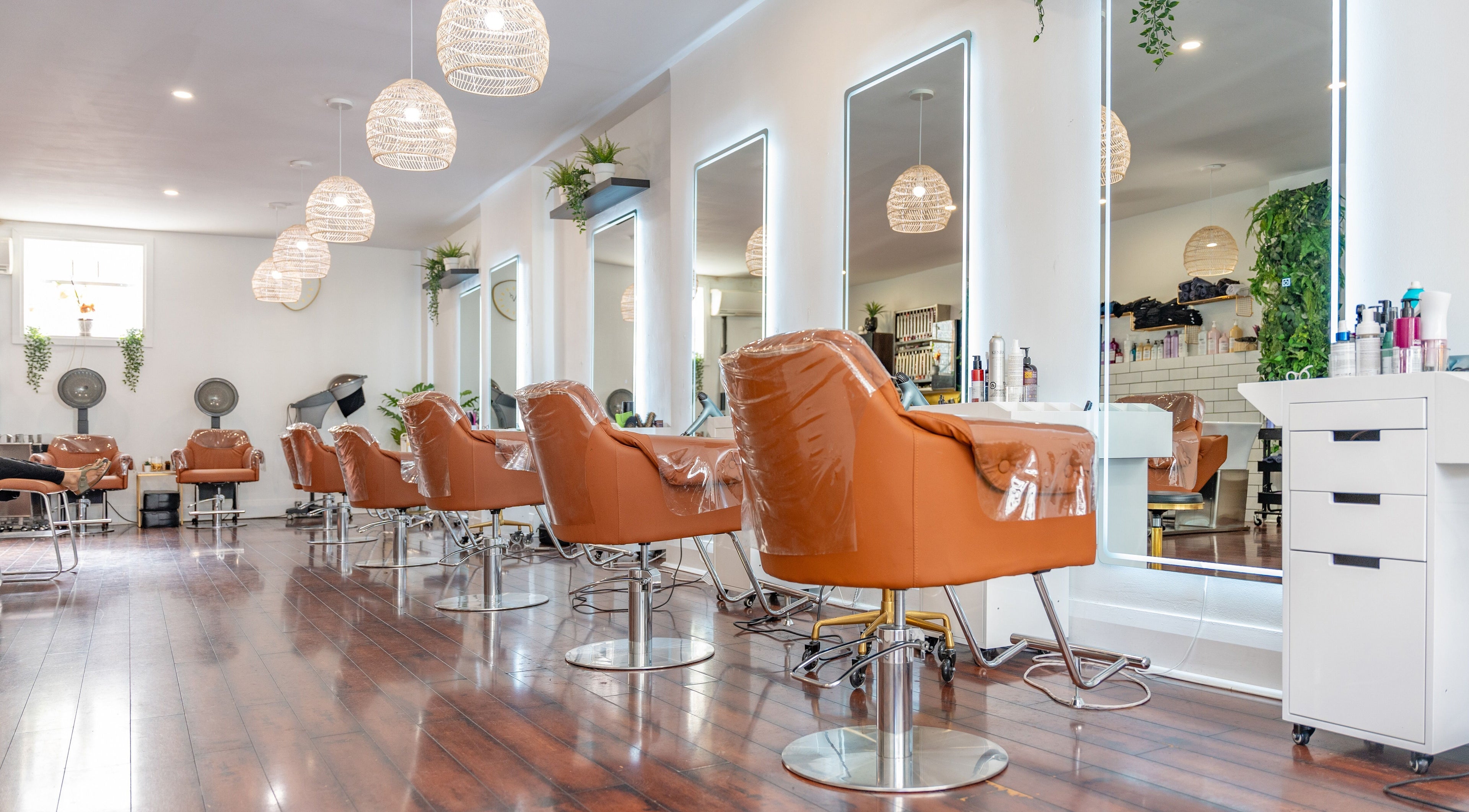 Modern salon interior with plush chairs at The Curl Lounge, Toronto, Ontario, CA, showcasing sleek design aesthetics.