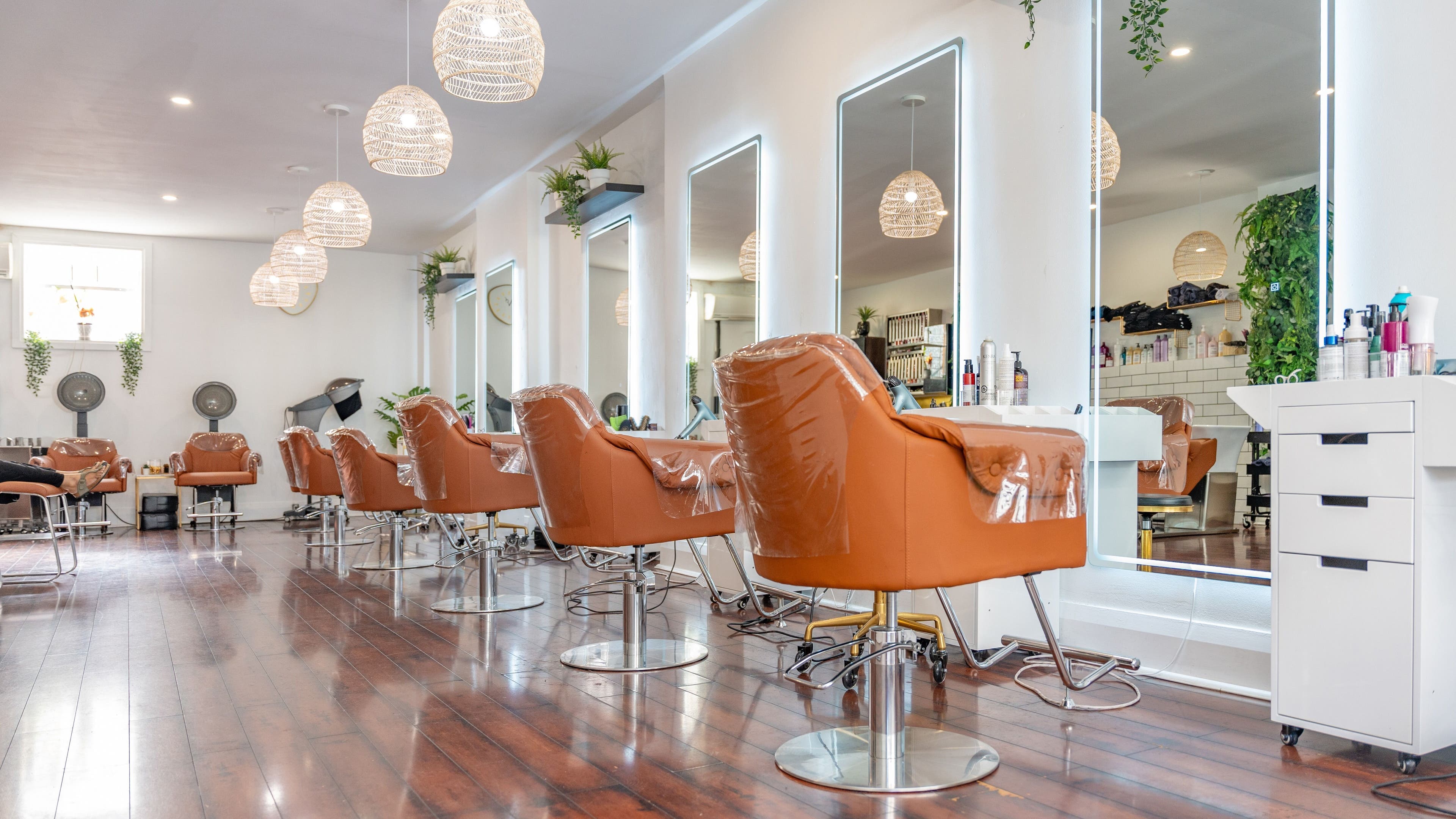 Modern salon interior with plush chairs at The Curl Lounge, Toronto, Ontario, CA, showcasing sleek design aesthetics.