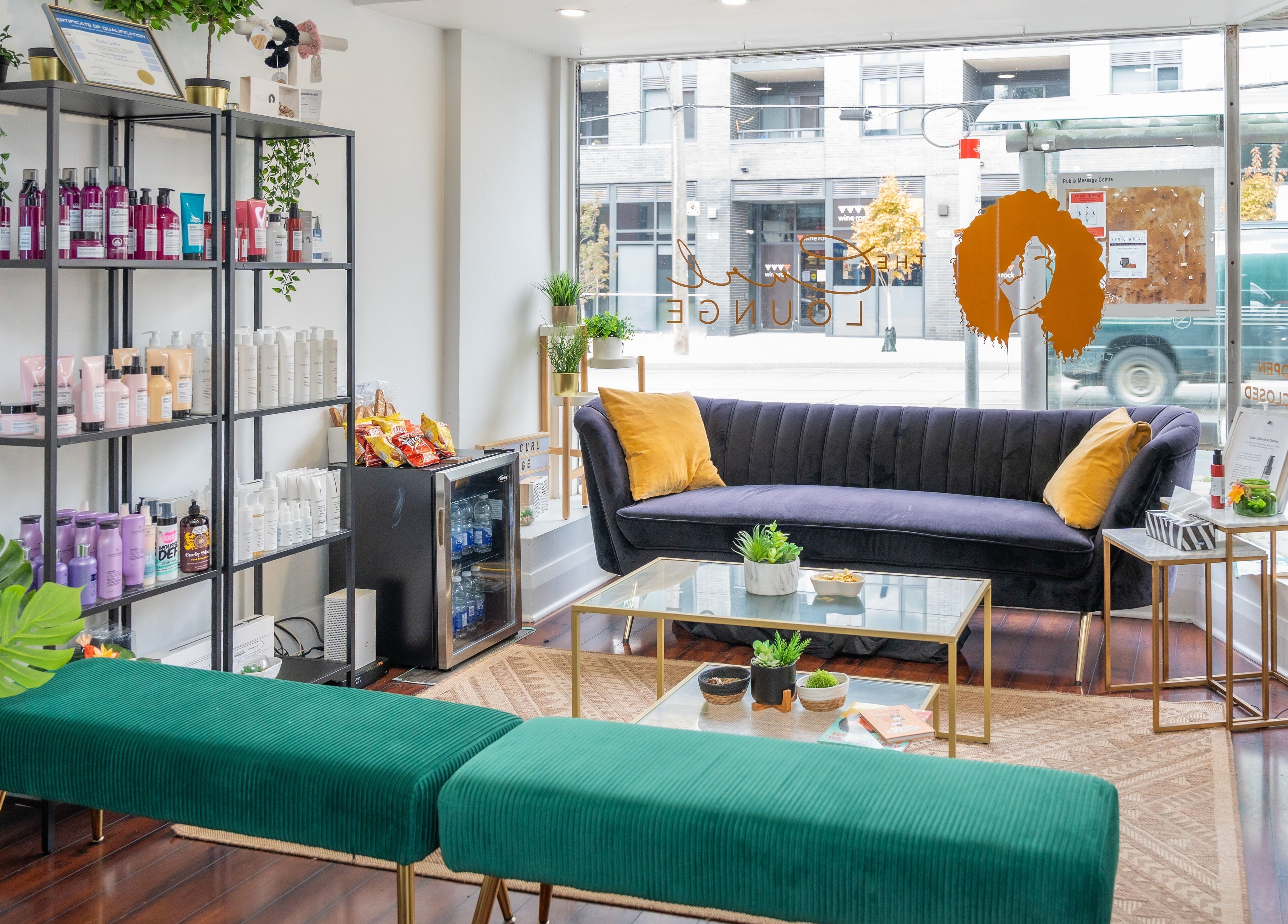Chic interior of The Curl Lounge in Toronto, Ontario, CA with plush seating and beauty products on display.